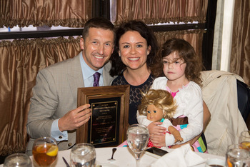 Dr. Michael Policastro displays his award with his family